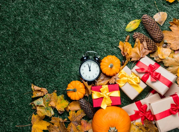 Alarm clock and orange pumpkins — Stock Photo, Image