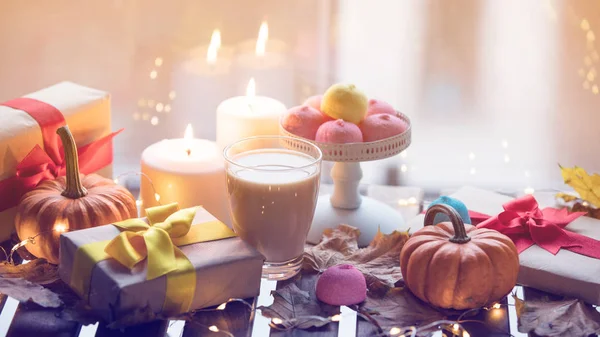 Cup of coffee, pumpkin, gifts and candles — Stock Photo, Image