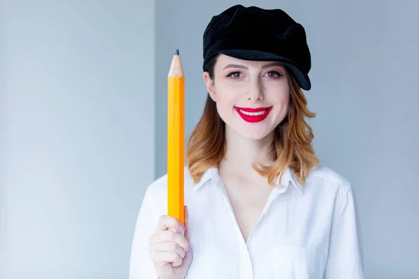 Young woman holding pencil — Stock Photo, Image