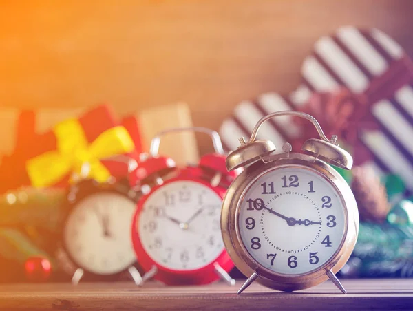 Alarm clocks with Christmas gifts — Stock Photo, Image