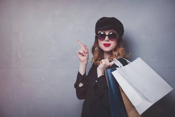 Girl in hat with shopping bags — Stock Photo, Image