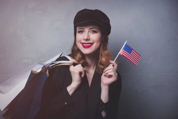 Girl with shopping bags and flag — Stock Photo, Image