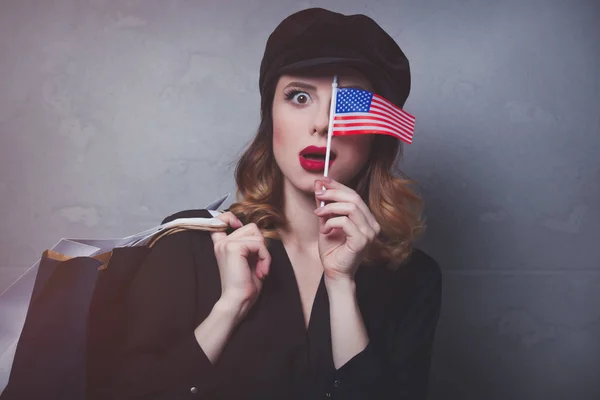 Girl with shopping bags and flag — Stock Photo, Image