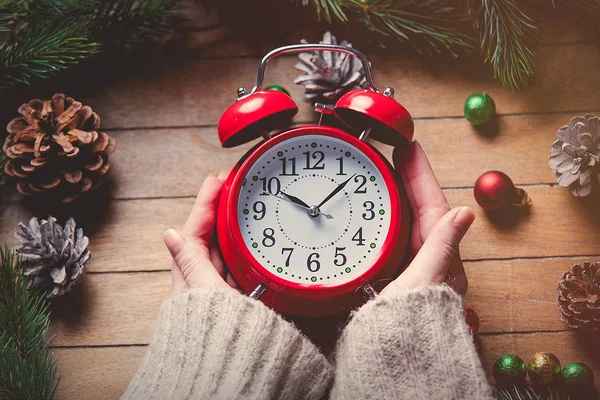 Female hands holding clock — Stock Photo, Image