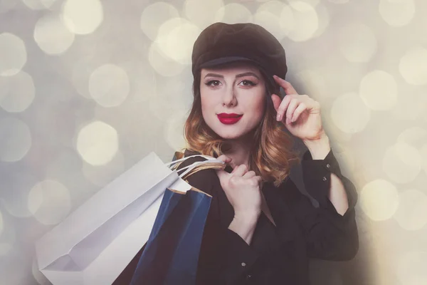 Girl in hat with shopping bags — Stock Photo, Image