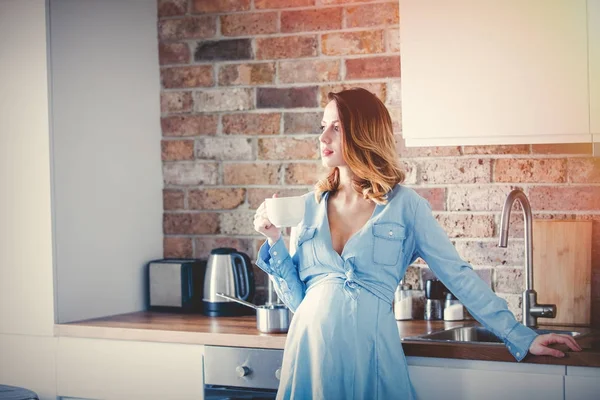 Pregnant woman with cup of coffee — Stock Photo, Image