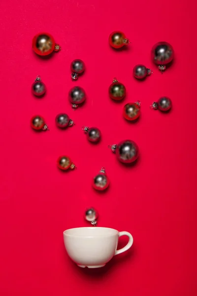 White cup and Christmas baubles — Stock Photo, Image