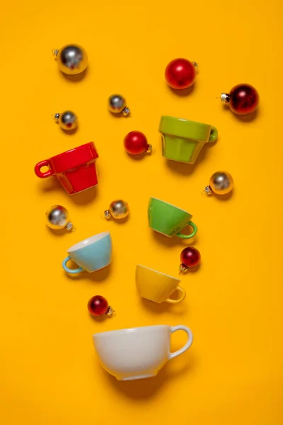 Color cups and Christmas baubles — Stock Photo, Image