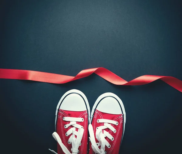 Red Gumshoes White Shoelaces Red Ribbon Grey Background — Stock Photo, Image