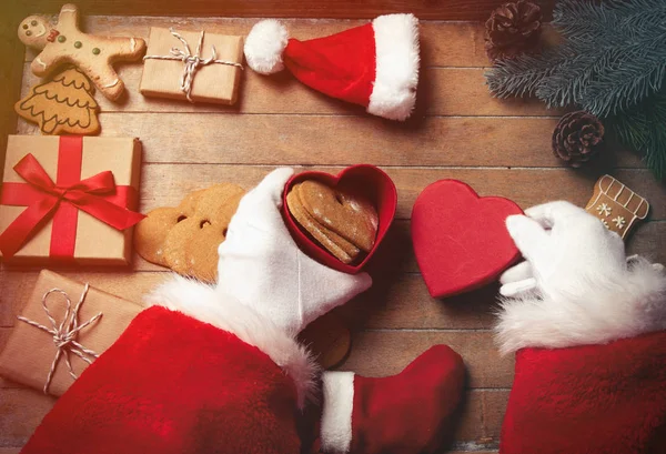 Santa Claus Envuelve Regalos Navidad Galletas Sobre Fondo Madera Antes —  Fotos de Stock
