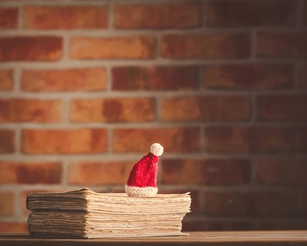 Christmas hat and old books — Stock Photo, Image