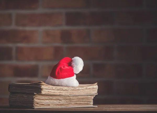 Christmas hat and old books — Stock Photo, Image