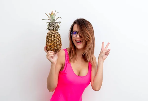 woman in swimsuit with pineapple