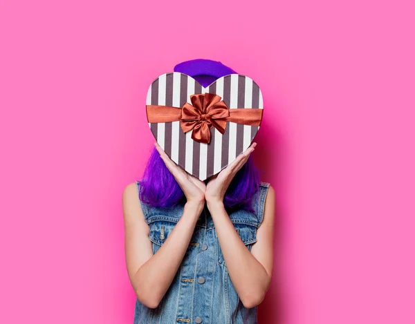 年轻时尚女孩的肖像与紫色的发型与情人节礼物盒粉红色背景 — 图库照片
