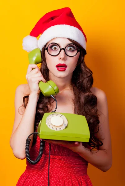 Chica en vestido rojo y Santa Claus con auricular —  Fotos de Stock