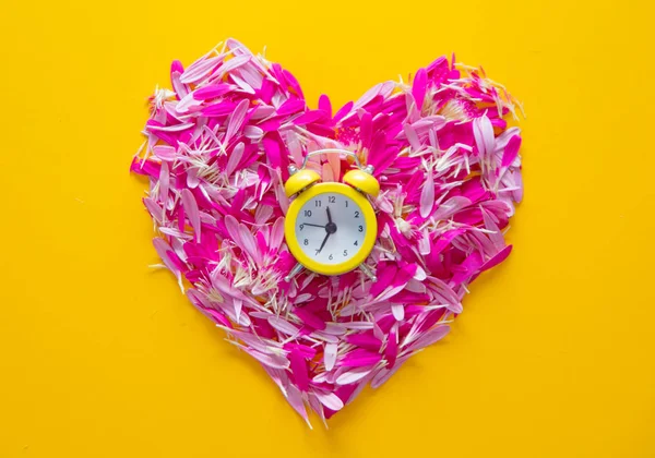 Etals in heart shape with little alarm clock — Stock Photo, Image