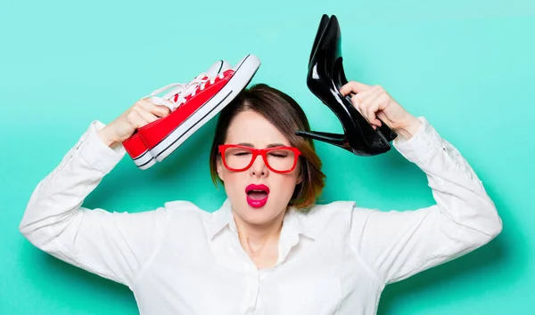 Young woman with shoes and gumshoes — Stock Photo, Image