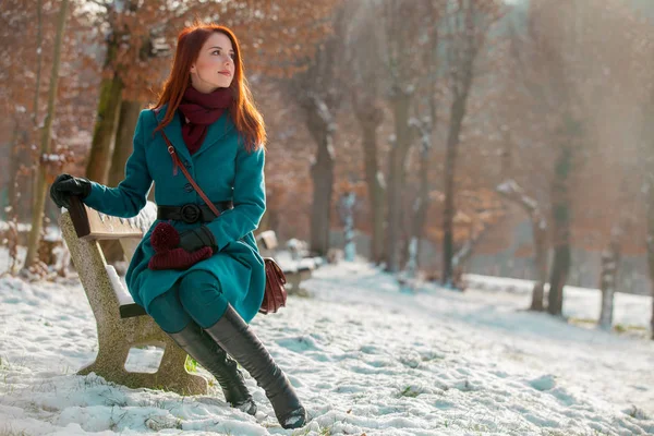 Young Redhead Girl Coat Sitting Bench Winter Sunny Day — Stock Photo, Image