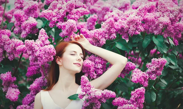 Young Redhead Girl White Dress Standing Lilac Bushes Park Springtime — Stock Photo, Image