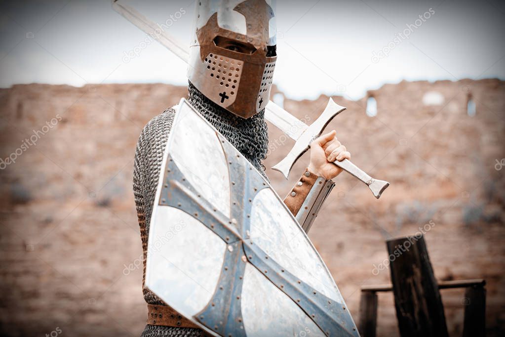 medieval armed knight with sword and shield. Image in old color style 