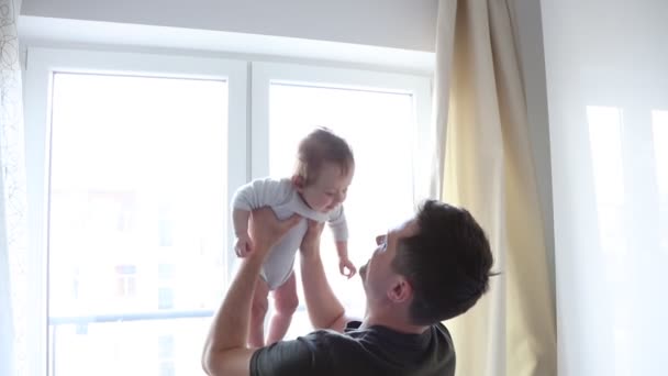 Young Father Playing His Little Son Standing Window — Stock Video