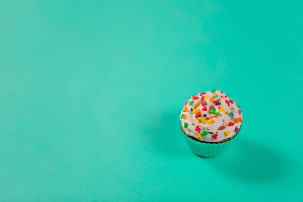Delicious cupcake on blue background. Above point of view
