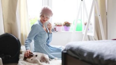Genç kız pembe saçlı ve bere ile köpek vasıl ev. Trendy tarzı kıyafetler 