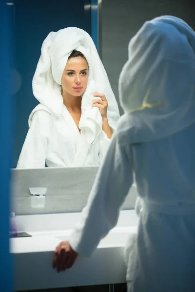 Mladá žena poblíž zrcadla v hotelu — Stock fotografie