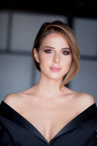 Young woman with makeup in black dress — Stock Photo, Image