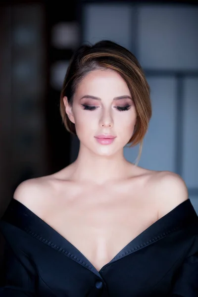 Young woman with makeup in black dress — Stock Photo, Image