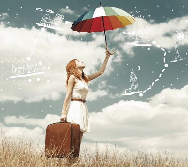 Beautiful redhead girl with umbrella and suitcase at outdoor. — Stock Photo, Image