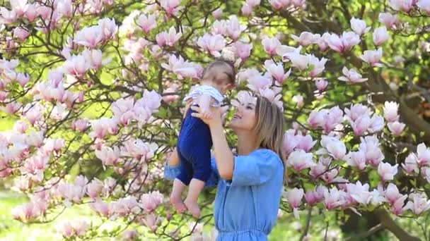 Young Redhead Mother Child Have Leisure Springtime Magnolia Flowering Garden — Stock Video