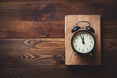 Küçük çalar saat ve kitaplar