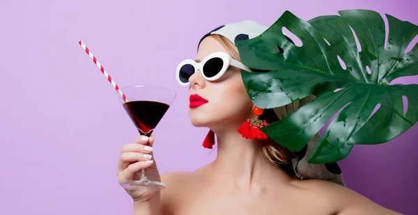 Femme en lunettes de soleil avec feuille de palme et cocktail — Photo