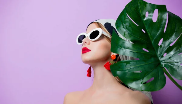 Woman in sunglasses with palm leaf — Stock Photo, Image