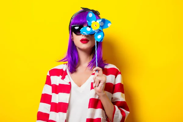 Menina com cabelo roxo segurando brinquedo pinwheel — Fotografia de Stock