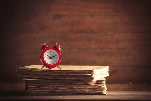 Little alarm clock and books — Stock Photo, Image