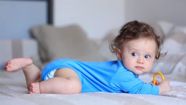 Little infant baby with alarm clock — Stock Video