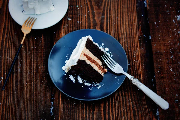 Christmas cake with fork and snow on wooden table. — Stock Photo, Image