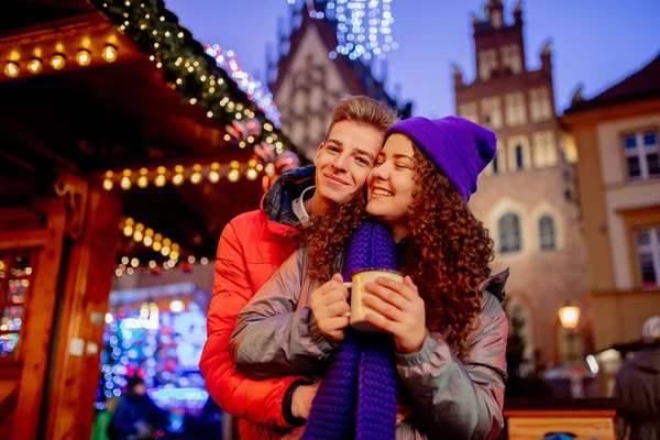 Молодая пара с напитками на Рождественской ярмарке во Вроцлаве, Польша — стоковое фото