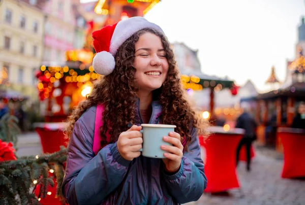 Молодая девушка с напитком на Рождественской ярмарке во Вроцлаве, Польша — стоковое фото