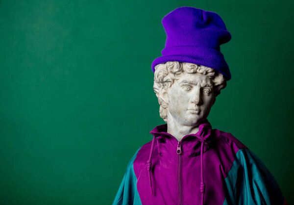 antique statue dressed in trendy clothes of the nineties on gree