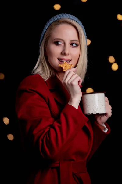 Girl with cup of coffee and gingerbread cookie — Stockfoto