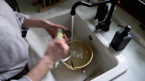 Woman washes a dish at kitchen — Stock Video