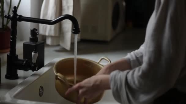 Mujer lava una sartén en su cocina — Vídeos de Stock