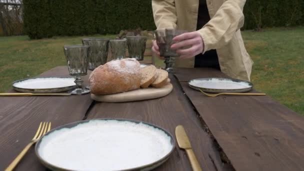 Mujer pone platos sobre la mesa — Vídeos de Stock