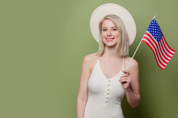 Beautiful cowgirl in a hat with United States of America flag — Stock Photo, Image