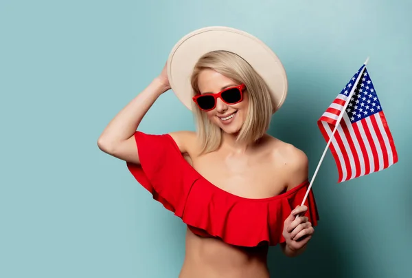Beautiful blonde woman in bikini with USA flag — ストック写真
