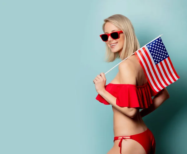 Beautiful blonde woman in bikini with USA flag — ストック写真