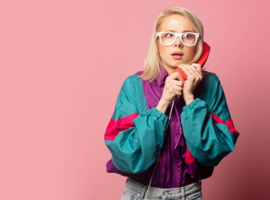 Beautiful blonde woman in 90s clothes with headset 